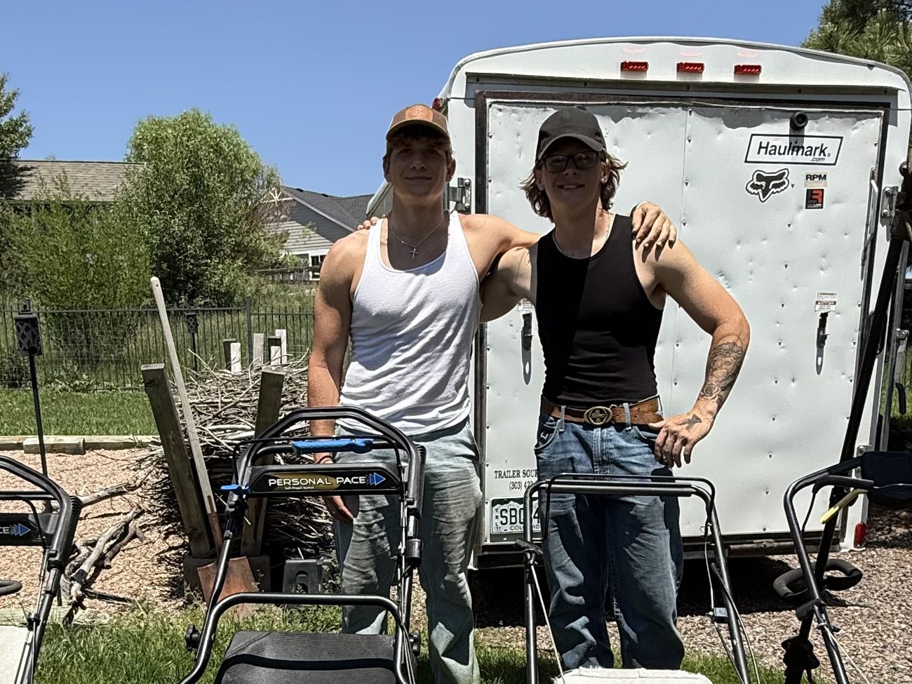 Eli and Stefen, owners of True Trim Lawns, with their mowing equipment